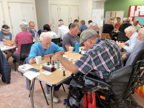 Wide shot of the teams playing chess